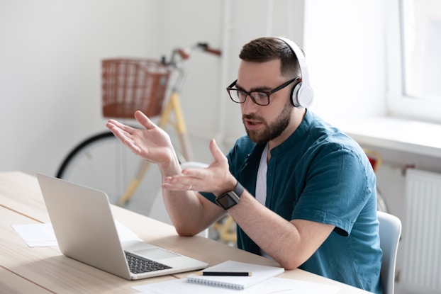 man on video call working remotely