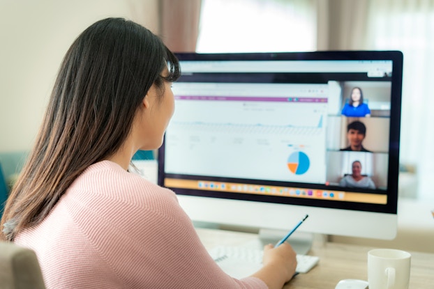 woman on videoconference with coworkers